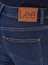 กางเกงยีนส์ผู้ชาย RAMONE FIT เอวต่ำ ทรงเข้ารูป สียีนส์กลาง